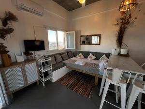 a living room with a couch and a table at Antiparos Private House Agios Georgios in Antiparos