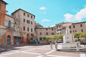 an empty street in an old town with buildings at La Foresteria dell'Aia in Castelnuovo Berardenga