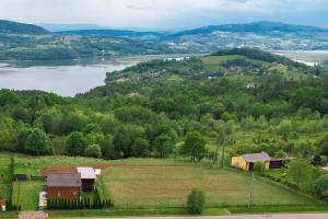 an aerial view of a farm and a river at Domek na wzgórzu in Tabaszowa +19 photos