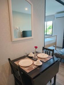 een eettafel met 2 stoelen en een spiegel bij В11 Title Naiyang Ватсап669З5В2I976 in Nai Yang Beach