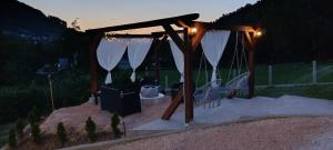 a playground with a toilet under a canopy at night at Holiday Residence Šehić in Visoko