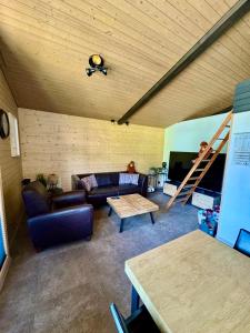 una sala de estar con un sofá y una mesa en Ferienwohnung Brunni-Lodge direkt im Skigebiet, en Alpthal