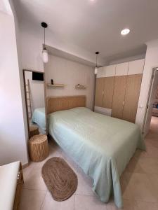 a bedroom with a large bed in a room at Blue Bay Beach Apartment - Maria in Sesimbra