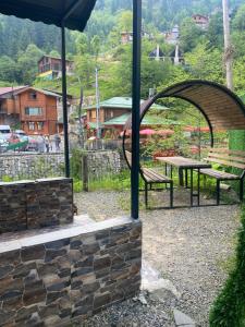 a picnic table and a bench in a park at Ayder Villas in Çamlıhemşin +20 photos