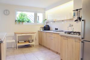 a kitchen with wooden cabinets and a window at Anka in Władysławowo
