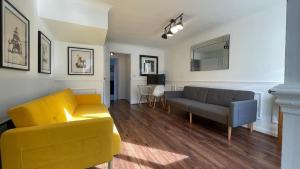 a living room with a yellow couch and a chair at The Witton 3-bed in Stockton-on-Tees