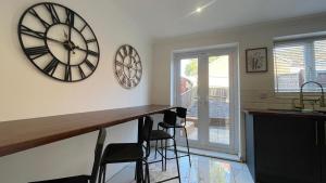 a kitchen with a large clock on the wall at The Witton 3-bed in Stockton-on-Tees
