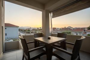 a table and chairs on a balcony with a view at Lumi Apartments in Gevgelija