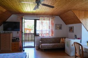 a living room with a couch and a window at Pension Eger in Treuchtlingen
