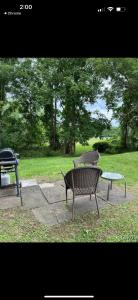 two benches and a table in a park at 105 Robert Drive in Syracuse