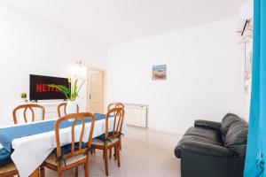 un salon avec une table, des chaises et un canapé dans l'établissement Sea La Vie, 5 minuti dalla Cinta, à San Teodoro