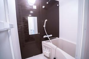 a bathroom with a shower with a mirror and a sink at 5 min walk from Gotanno station 20sqm apartment with private toilet and bathroom Direct access to popular travel destinations such as Ueno in Tokyo +26 photos