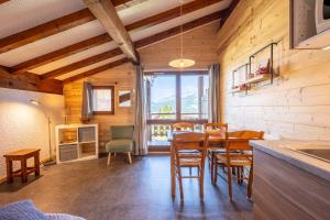 a kitchen and dining room with a table and chairs at Studio 18 - Le Chamois in Crest-Voland
