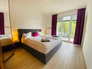 a bedroom with a large bed and a mirror at Villa Mira in Klopein am Klopeiner See