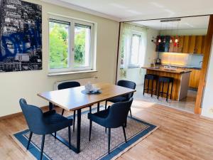 a dining room with a wooden table and chairs at Villa Mira in Klopein am Klopeiner See