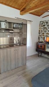 a kitchen with a sink and a stove at Mandal Cottage in Samothraki
