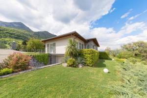 a house with a grassy yard in front of it at Villa Miraggio by MyVillaCollection in Tremezzo +39 photos