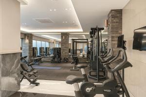 a gym with several treadmills and cardio machines at Zizel Suite Room Seocho in Seoul