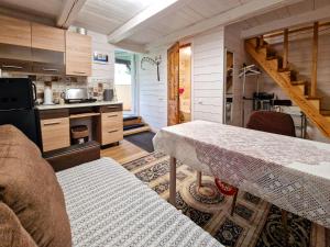 a small kitchen with a table in a room at RYTO GARSAI in Merkinė