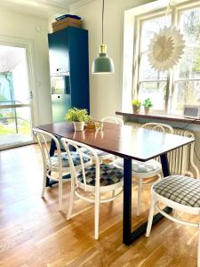 a dining room with a table and chairs at Village house & garden for summer hangout near Sankt Olof in Onslunda