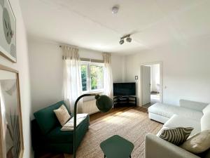 a living room with a couch and a chair at Gemütliche Ferienwohnung in Emmerich