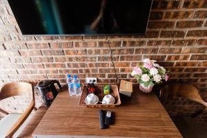 a table in a room with a brick wall at Tam Coc Mr Loa Bungalow in Ninh Binh