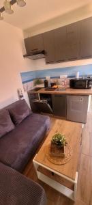a living room with a couch and a table at Domek Herada 2 in Jastarnia
