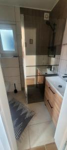 a small bathroom with a sink and a toilet at Domek Herada 2 in Jastarnia