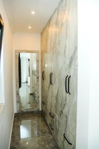 a hallway with a stone wall with a mirror at Villa Kaan in Ortaca