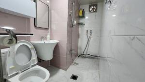 a bathroom with a toilet and a sink and a shower at Dongdaemun Myeongdong 6BED in Seoul +16 photos
