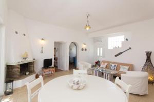 a living room with a white table and chairs at Villa Maria, Golden Beach, Paros in Kampos Paros
