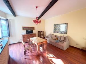 a living room with a table and a couch at Eulalia Apartment in Cagliari