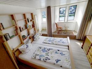 1 Schlafzimmer mit 2 Betten in einem Zimmer mit Fenstern in der Unterkunft Mosel View Old Town Apartments in Zell an der Mosel