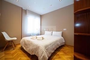 a bedroom with a bed with two towels on it at Antoxana By Silastur in Luanco