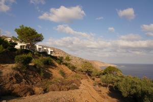 a house on the side of a hill overlooking the ocean at House of Harmony Standaard studio Mira ADULTS ONLY in Achlada
