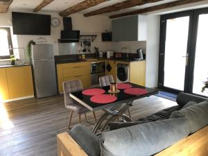 a living room with a table and a kitchen at La Grange des Riders in Saint-Lary-Soulan