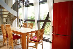 a dining room with a wooden table and chairs at Landhaus 3 Stettinerhaff in Dargen