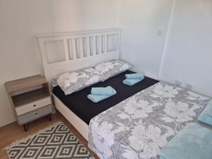 a bedroom with two beds and a night stand at Apartman Lopar 2,Crikvenica in Crikvenica