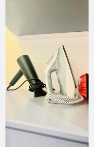 a phone and a pair of shoes on a shelf at Naroc1 in Lille