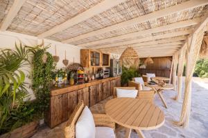 an outdoor living room with a table and chairs at Can Aisha in Es Pujols