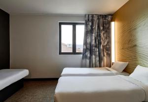 Postel nebo postele na pokoji v ubytování B&B HOTEL Argenteuil