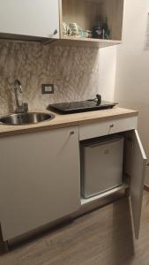 a kitchen with a sink and a counter with a sink at Fiori di Loto Home in Iesi