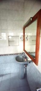 a bathroom with a sink and a mirror at Greenoriva Aero Srinagar in Srinagar +47 photos