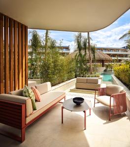a living room with a couch and chairs and a pool at XO CAPE ARNNA Fethiye in Fethiye
