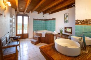 a large bathroom with a tub and a sink at Two-Villa Estate with Pool & Valley Views in Salvagnac-Cajarc