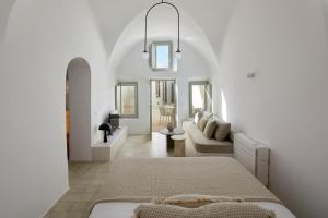 a white room with a bed and a couch at Thiro Bliss Villa with private jacuzzi in Pirgos +38 photos