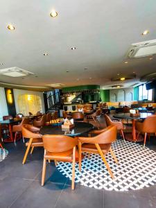 a restaurant with tables and chairs in a room at Rose Manor suites in Dehradun