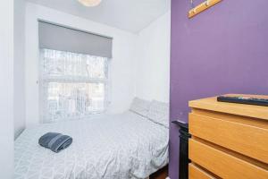 a small bedroom with a bed and a window at 4 Bedroom House For Corporate Stays in Kettering in Kettering +8 photos