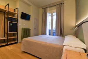 Posteľ alebo postele v izbe v ubytovaní Hotel Columbia