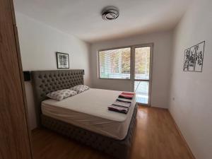 a small bedroom with a bed with a window at Nana's apartment in Varna City